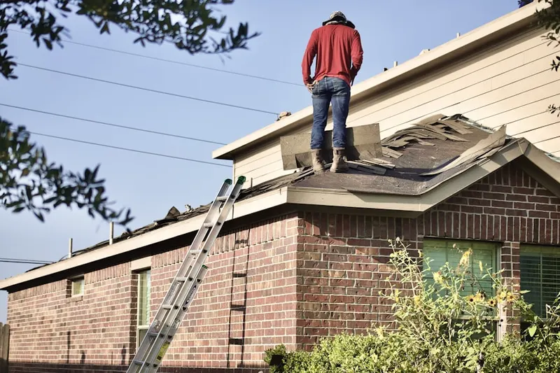 Professional roofer working on a residential roof in Minter